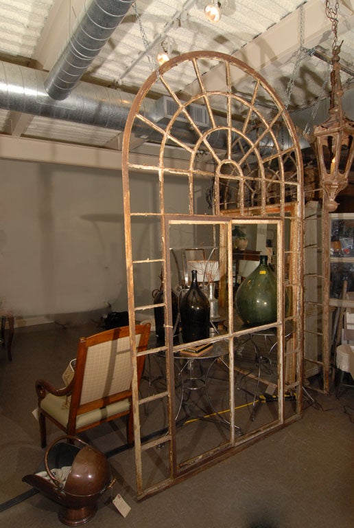 Rare pair of large iron window frames from an orangerie / conservatory / sunroom.  The center section pivots open for ventilation. 44 panes in each window.